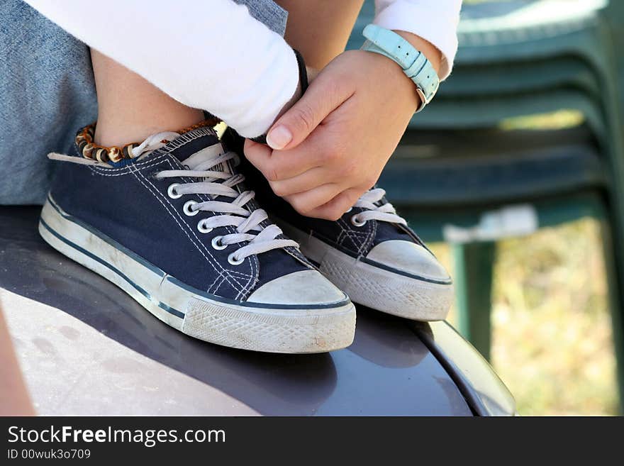 Woman's hands and legs on the car. Woman's hands and legs on the car