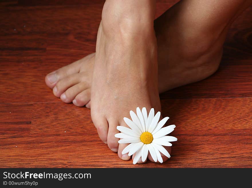 Holding flower on the feet. Holding flower on the feet