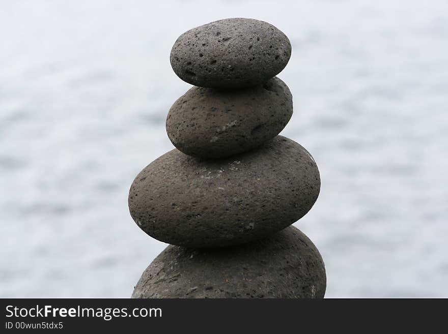 Balanced Stones on top of each other on ocean blue background