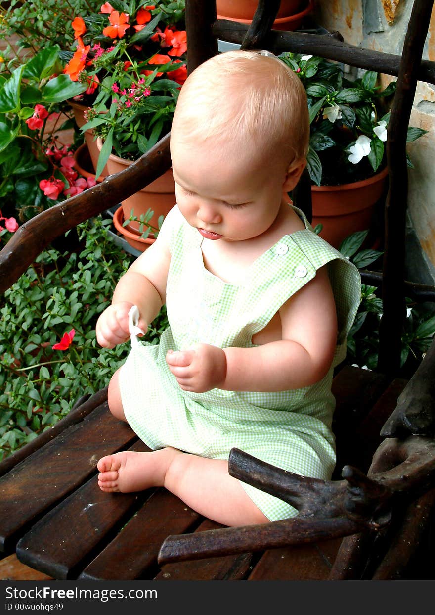 Baby boy on rocking chair on front porch of family home. Baby boy on rocking chair on front porch of family home