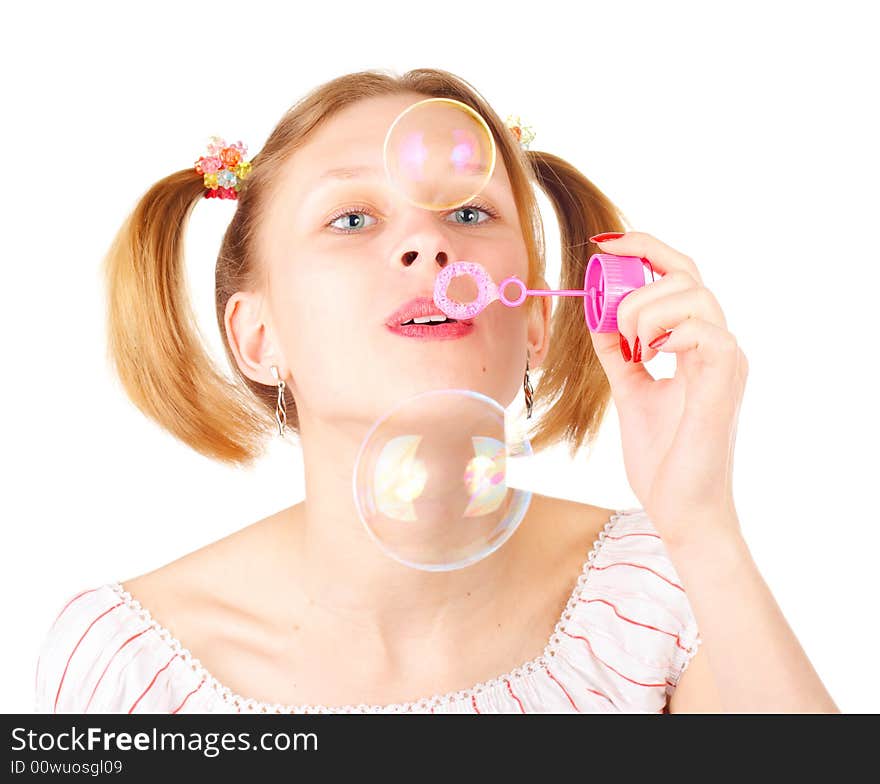 Pretty young girl with soap bubbles over white