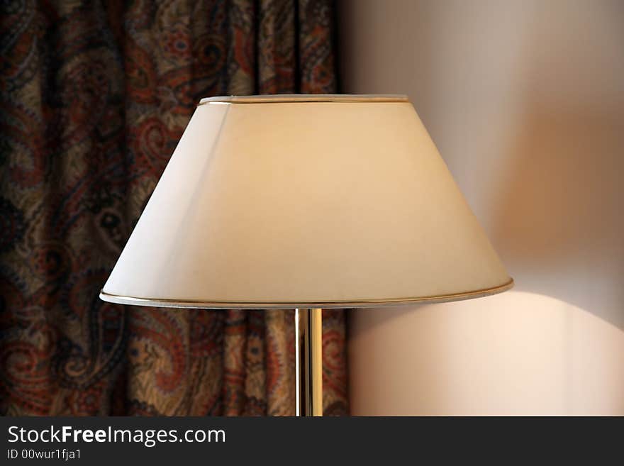 Floor lamp near a wall in a hotel room