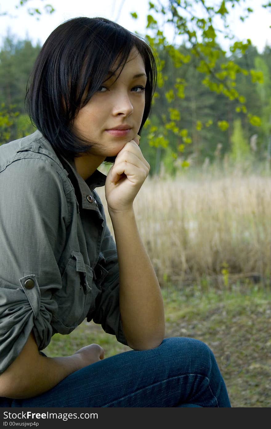 Young sad woman in the forest