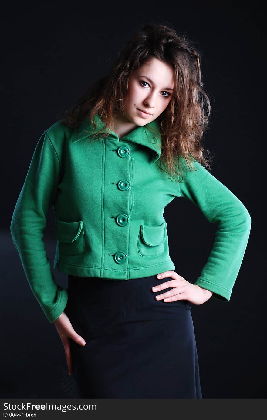 Beauty fashion woman in green clothes at black background. Beauty fashion woman in green clothes at black background