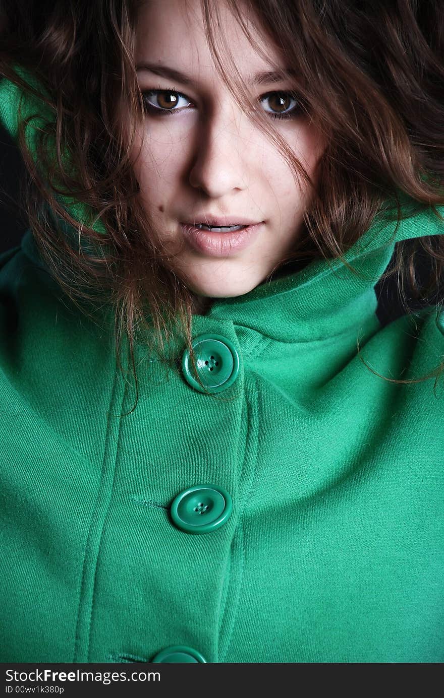 Beauty fashion woman in green clothes at black background. Beauty fashion woman in green clothes at black background