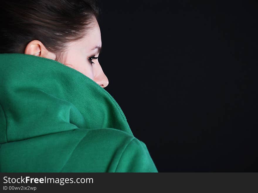 Beauty fashion woman in green clothes at black background. Beauty fashion woman in green clothes at black background