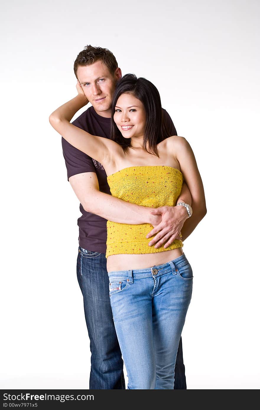 Caucasian guy and Asian posing romantically for their portrait. Caucasian guy and Asian posing romantically for their portrait