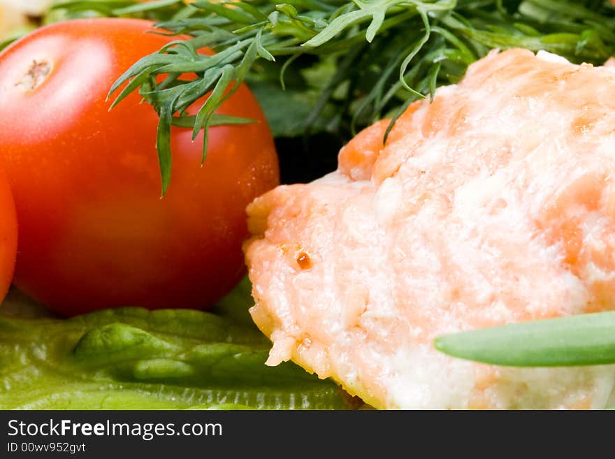 Stake from a salmon with vegetables on a plate