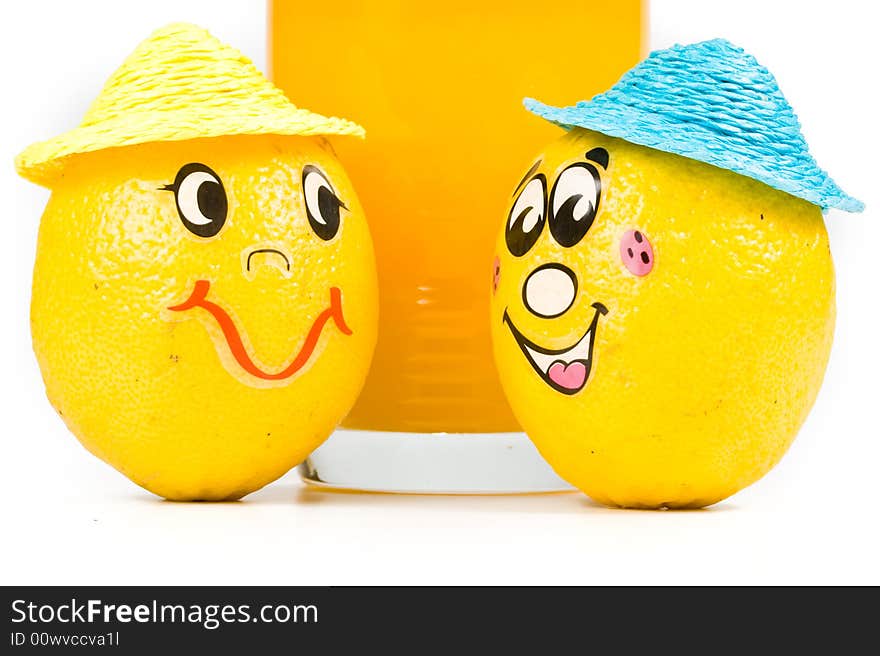 Cheerful little men from a fresh lemon and a juice glass isolated on a white background. Cheerful little men from a fresh lemon and a juice glass isolated on a white background