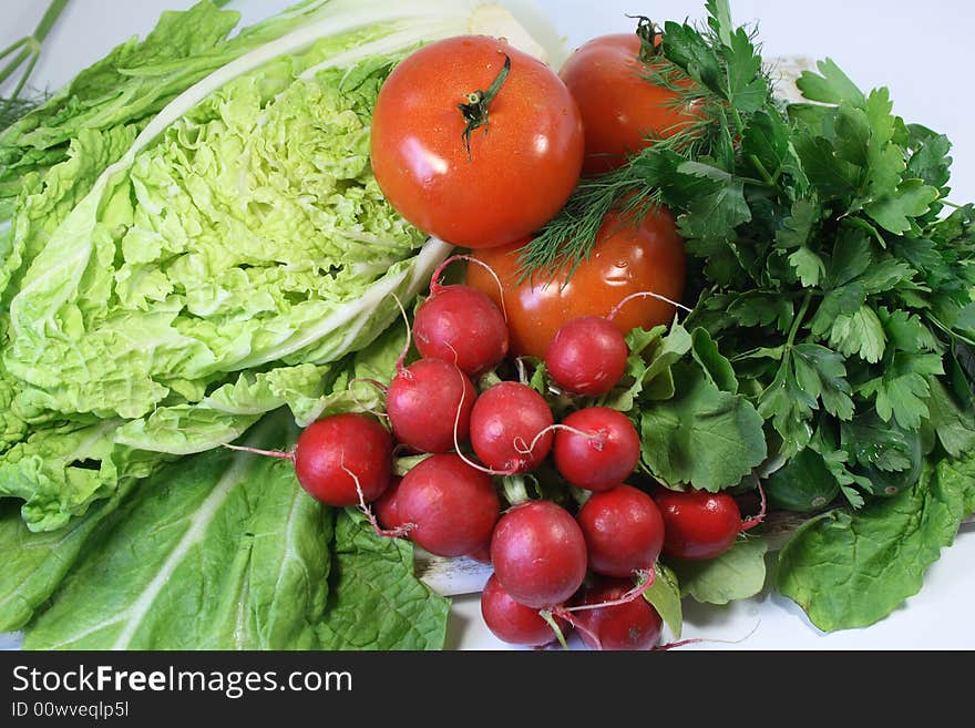 Garden radish, leaves of salad, tomatoes, cucumbers and parsley. Garden radish, leaves of salad, tomatoes, cucumbers and parsley.