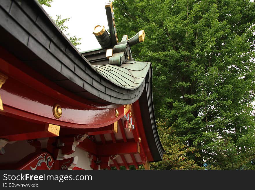 A photograph of a beautifully decorated roof of a japanese temple in Tokyo. A photograph of a beautifully decorated roof of a japanese temple in Tokyo.