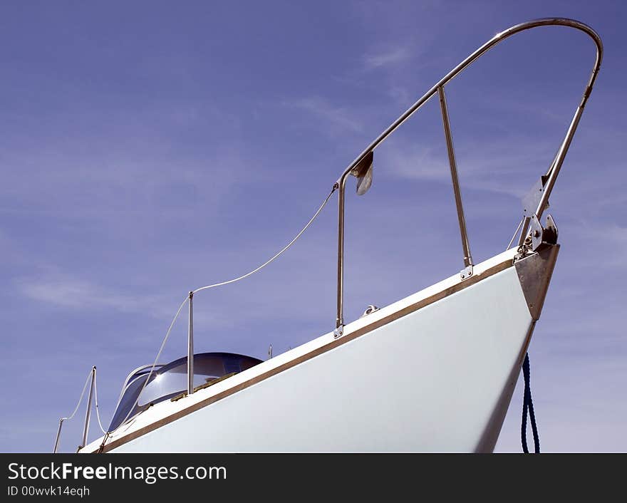 White boat from the front with a blue sky background