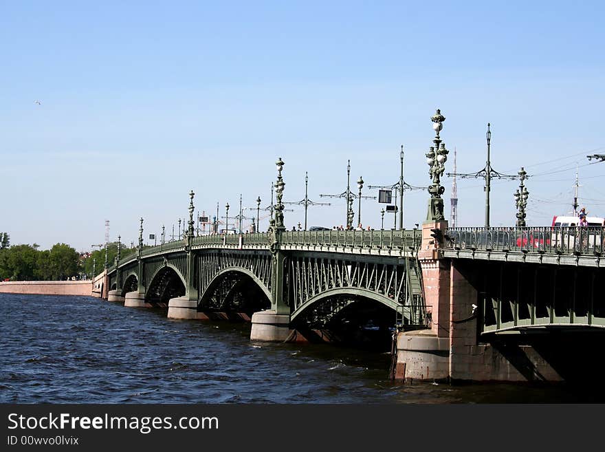 Urban landscape: drawbridge, river, trees, big city