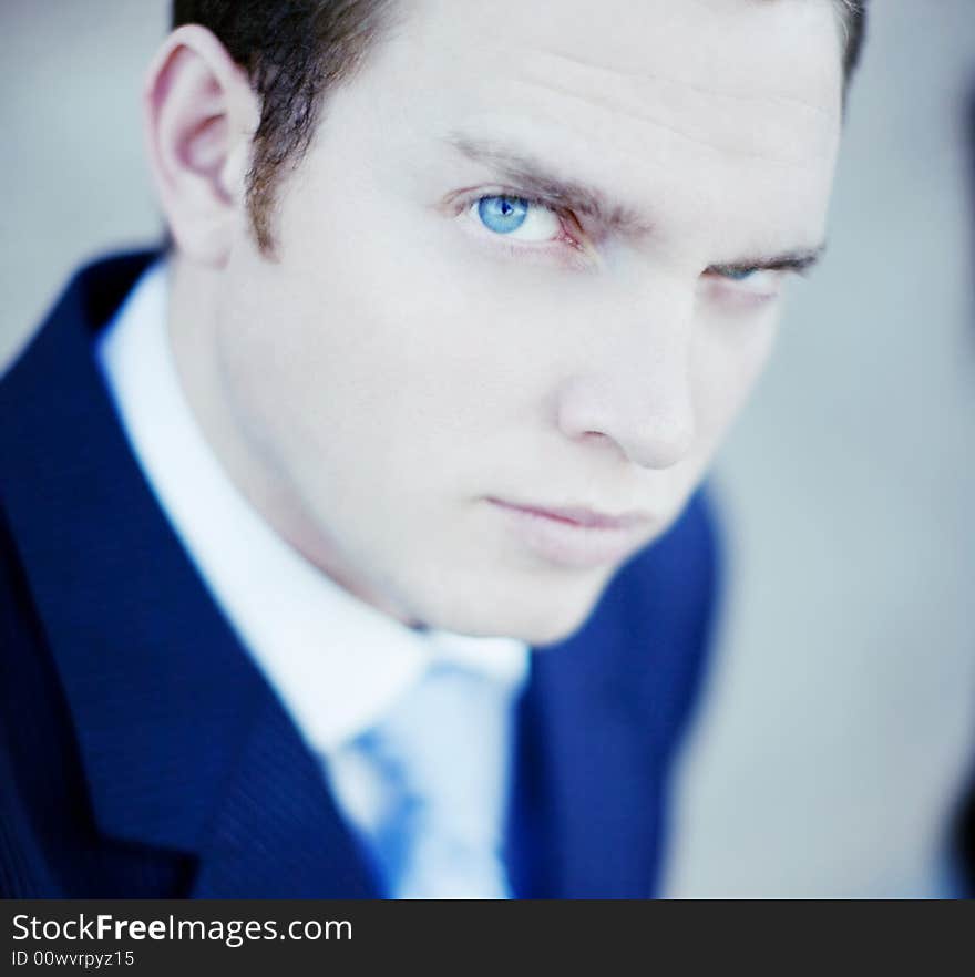 Close up of single white businessman wearing white shirt and blue tie. Close up of single white businessman wearing white shirt and blue tie