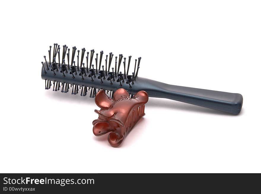 Hairbrush and hairpins on a white background