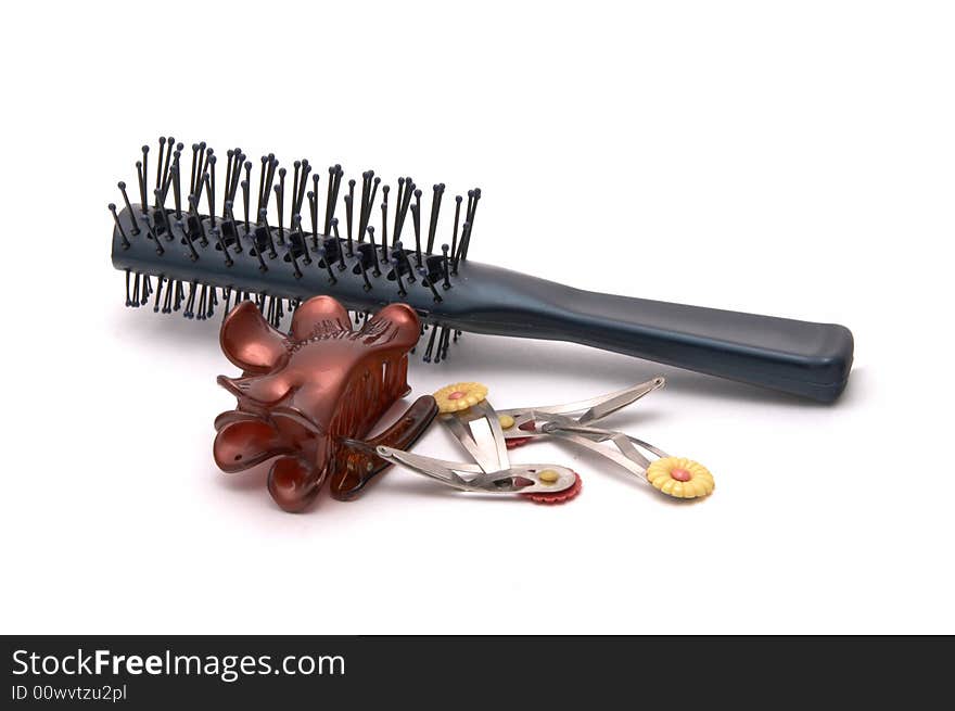 Hairbrush and hairpins on a white background