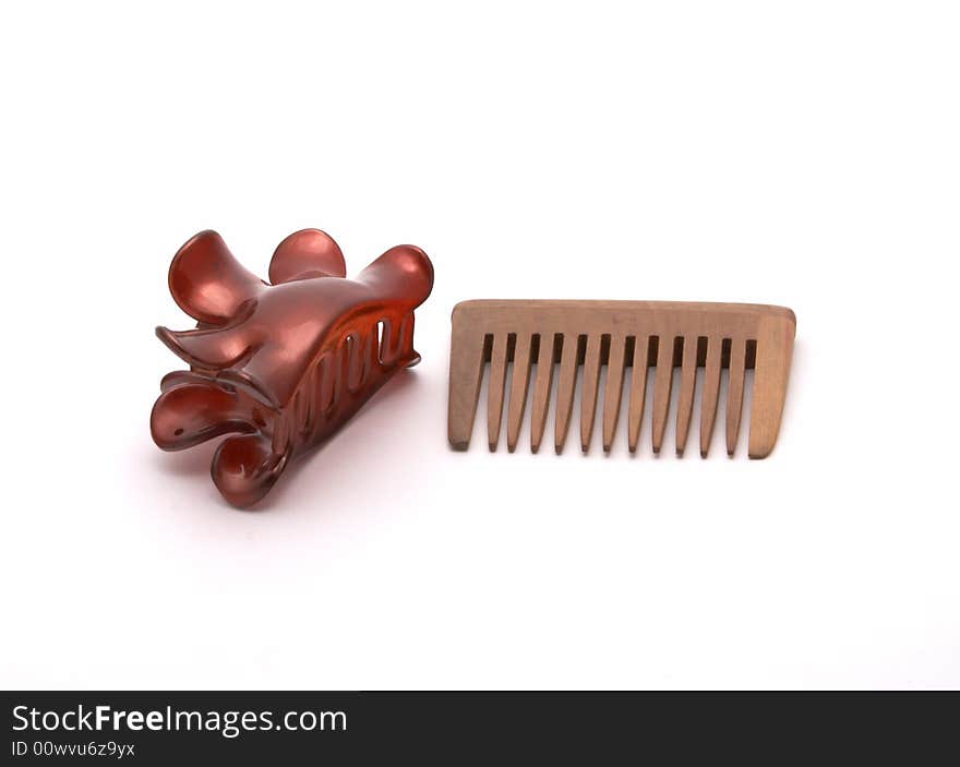 Hairbrush and hairpins on a white background