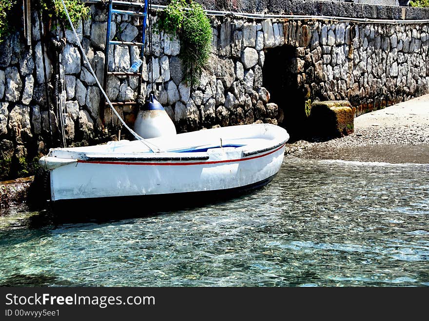 Rowboat to the stone pier. Rowboat to the stone pier