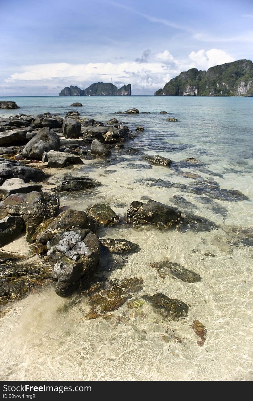 Coastline. Rocks in tropical water.