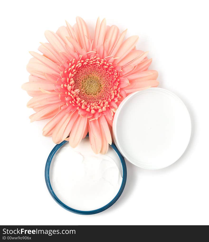 Moisturizing cream with pink gerbera close up