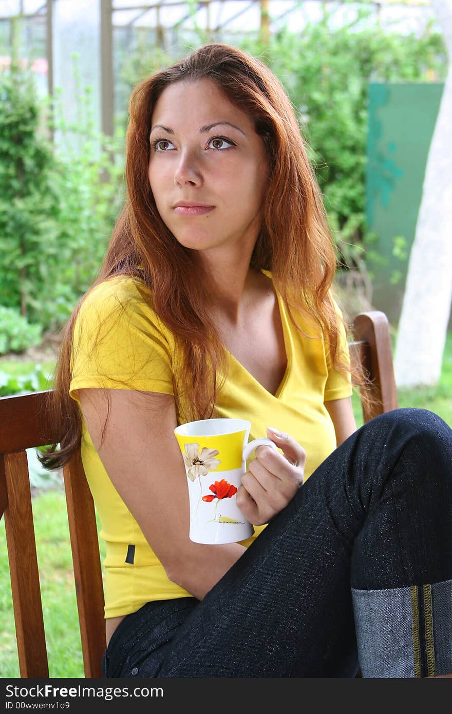 Girl is drinking tea outdoors