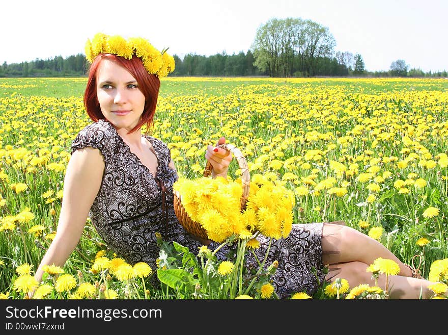 Beautiful redhead girl with basket of dandelions. Beautiful redhead girl with basket of dandelions