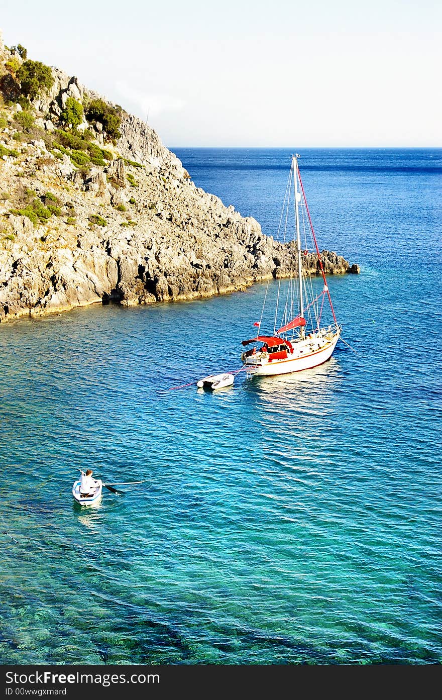 Pictorial scene with rocky beach and yacht. Pictorial scene with rocky beach and yacht