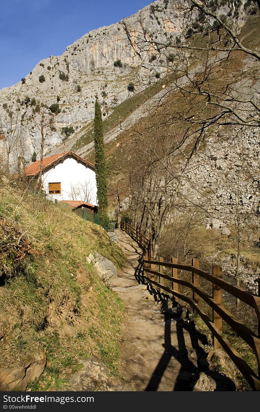 Path towards a house in mountains. Path towards a house in mountains