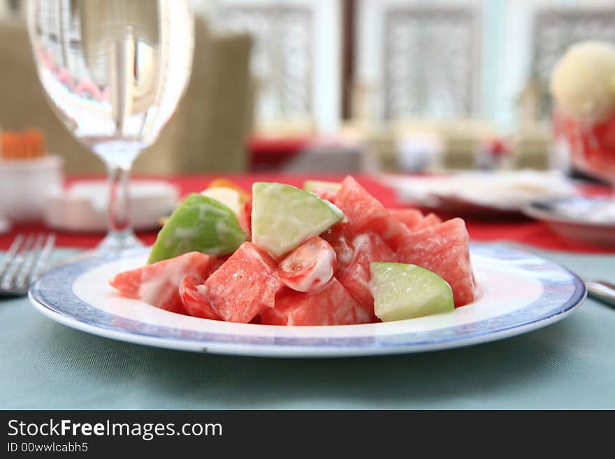 Appetizing salad on a plate with cup of drinking. Close up