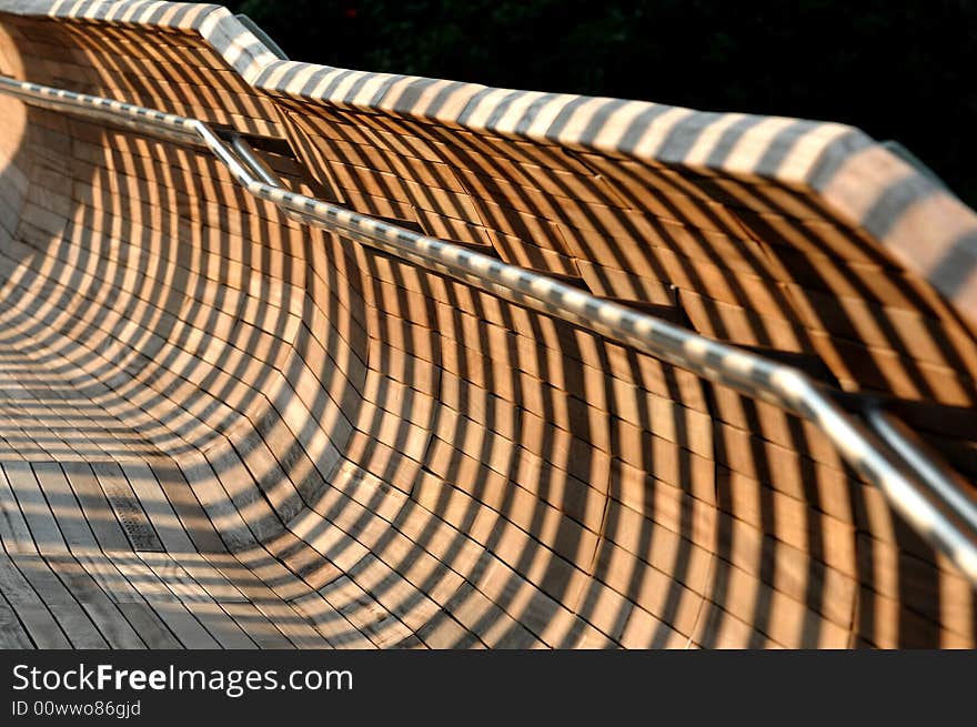 Shadows from an architecture forming striped shadows on a railing. Shadows from an architecture forming striped shadows on a railing