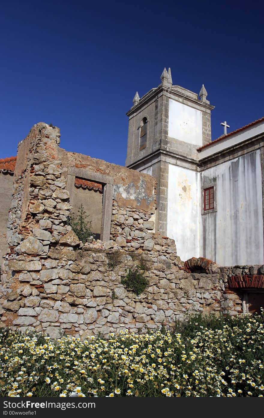 Old church over ruined castle, isolated in blue sky