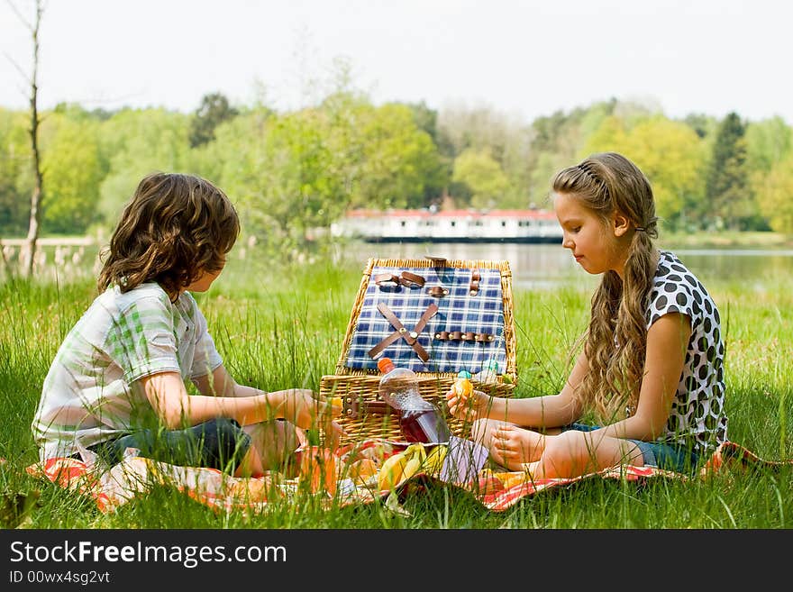 Two children enjoying a picnic in the summer. Two children enjoying a picnic in the summer