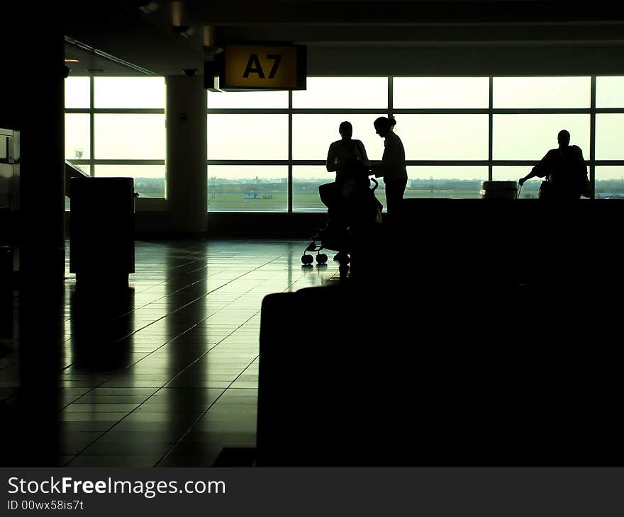 Silhouette of travelers in departure area of airport. Silhouette of travelers in departure area of airport