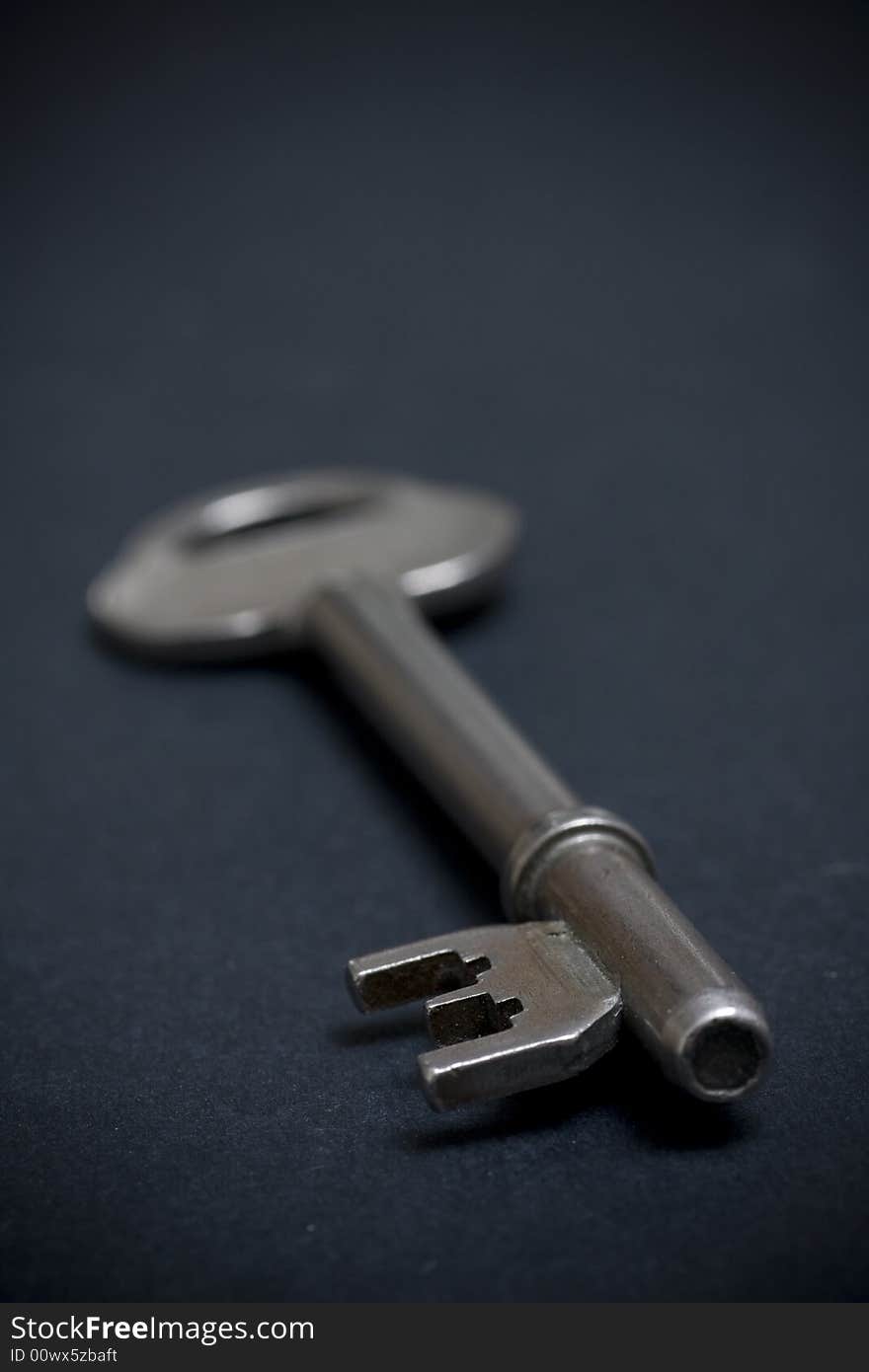 Door key on dark background