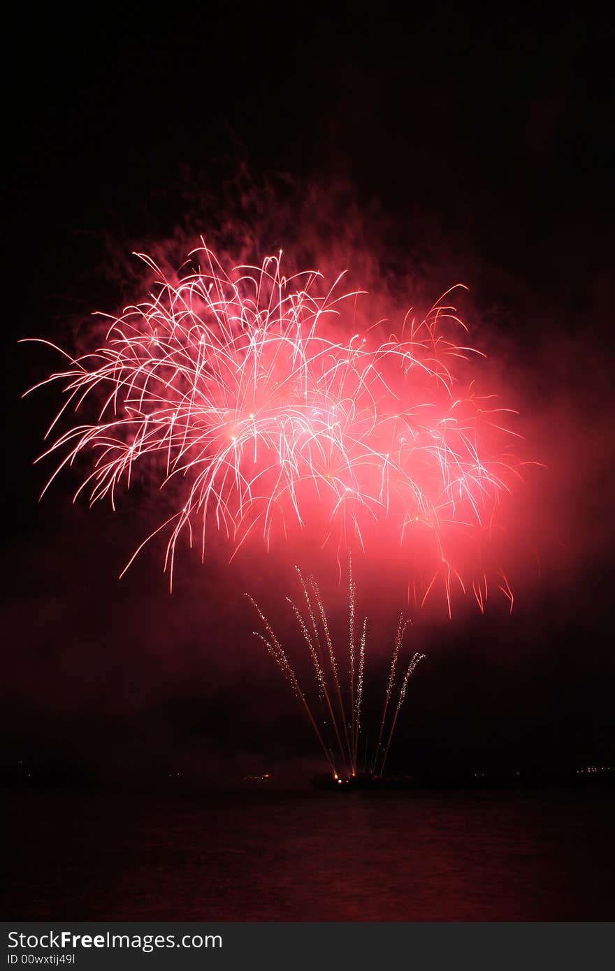 Bright red fancy fireworks against the dark sky