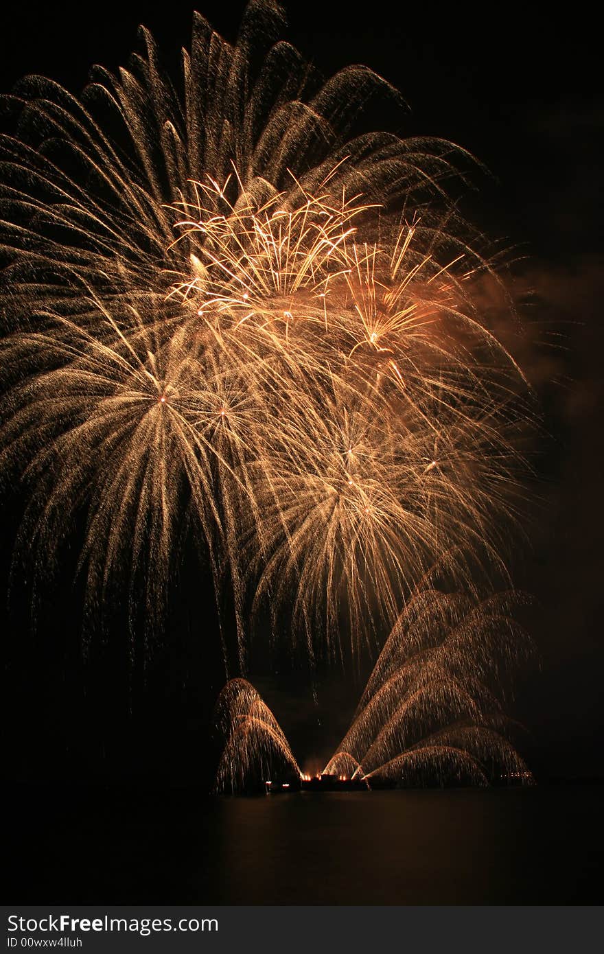 Bright yellow fireworks against the dark sky