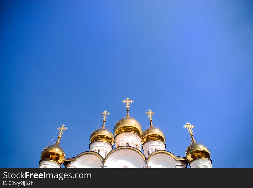 Golden church domes with copy-space