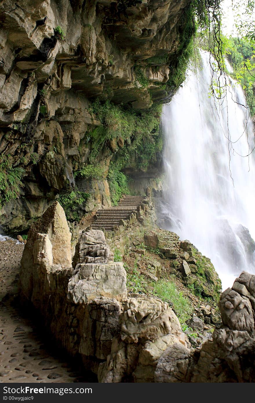 The beautiful waterfall with a road through it's behind. The beautiful waterfall with a road through it's behind