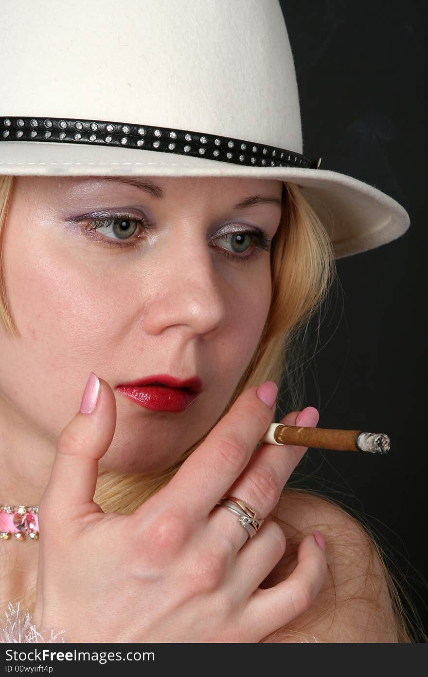 Lady with white hat smoking a cigarette