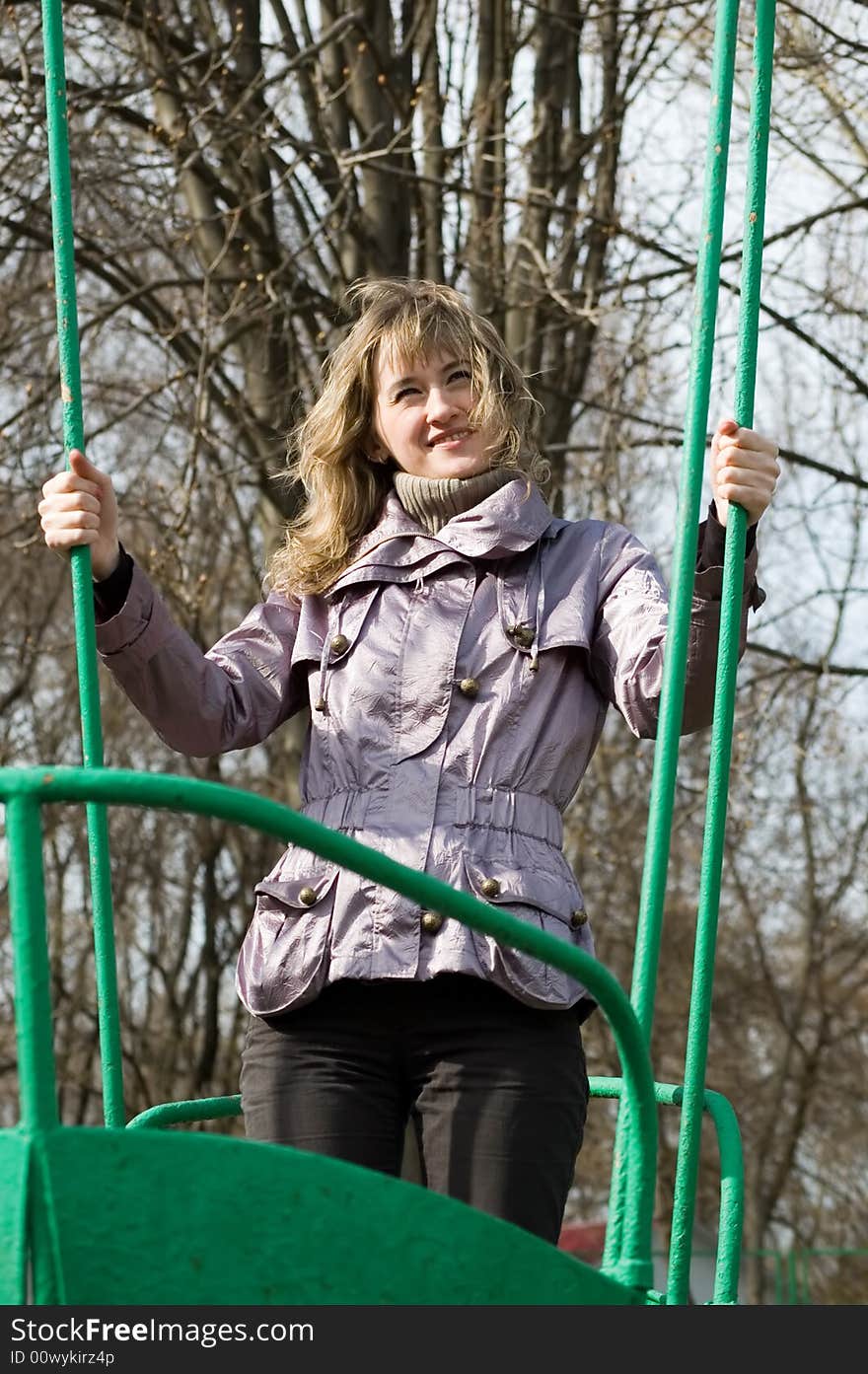 Girl in park on old swing