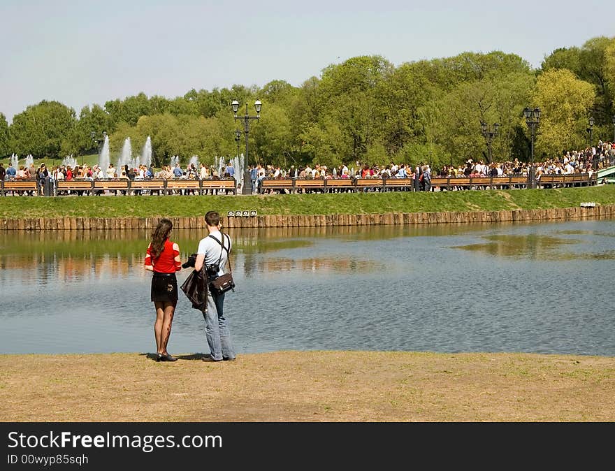 Married couple on a beach of park pond