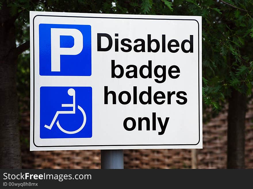 Shot of a disabled parking sign in a car park. Shot of a disabled parking sign in a car park