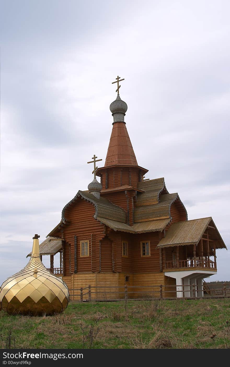 Wooden chapel with golden dome on the ground. Wooden chapel with golden dome on the ground