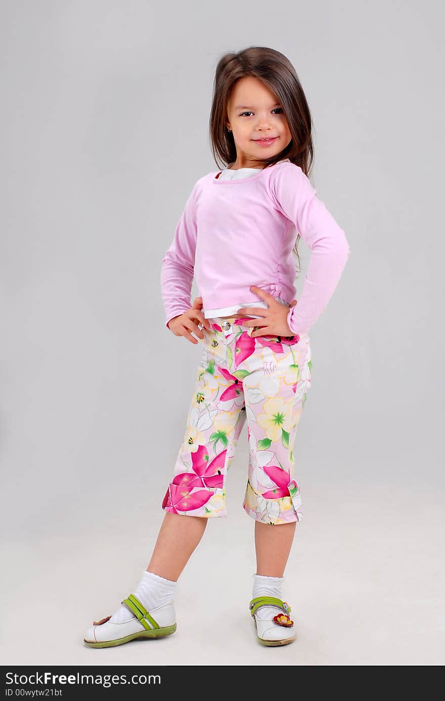 Cute smiling baby girl posing in brightly colored clothes. Cute smiling baby girl posing in brightly colored clothes