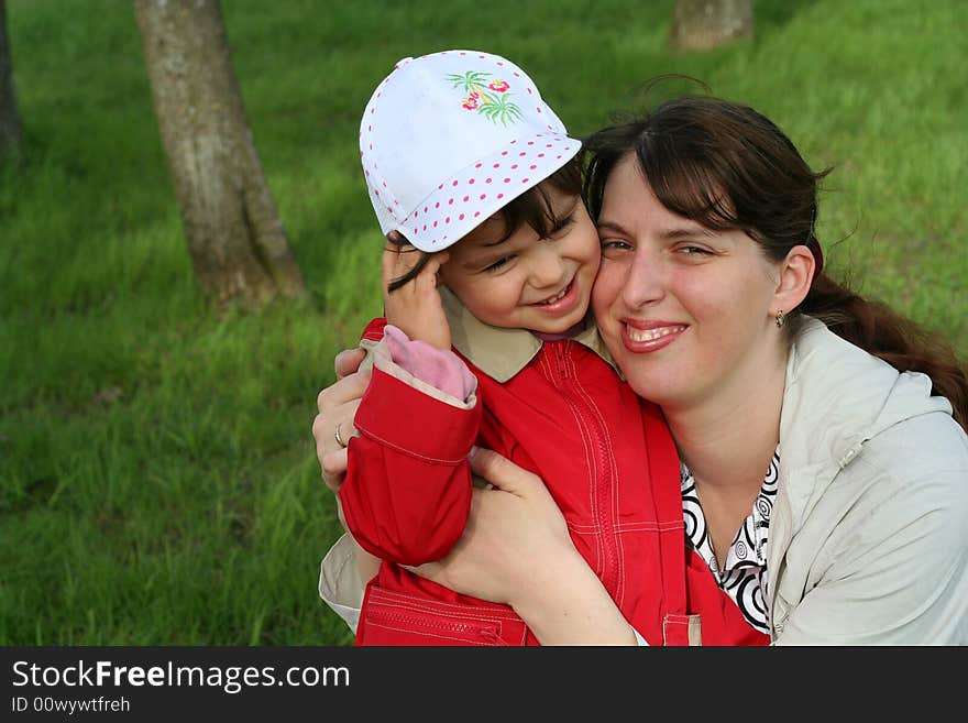 Little girl with her mother in the spring park