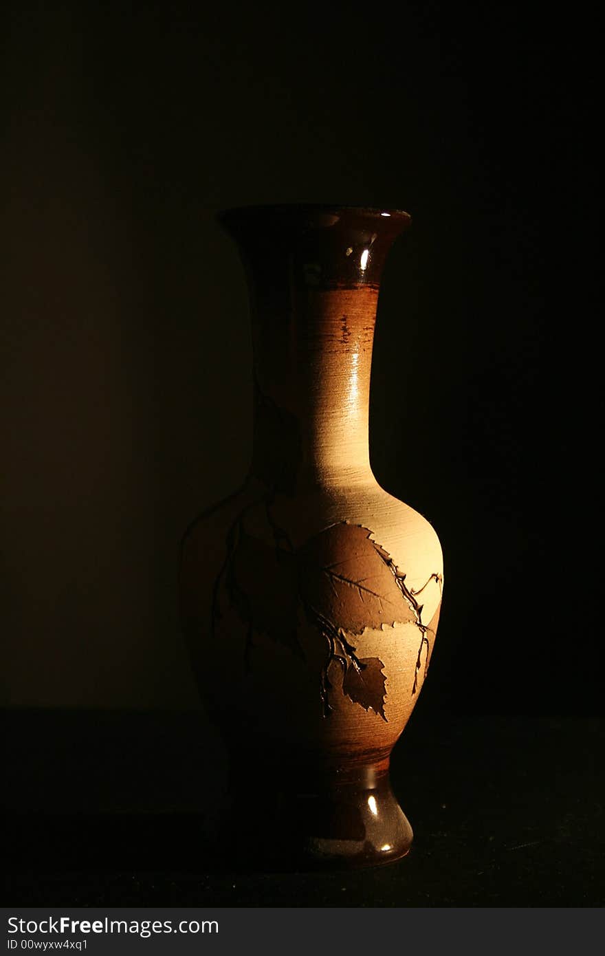 An old wooden vase on the black background. An old wooden vase on the black background