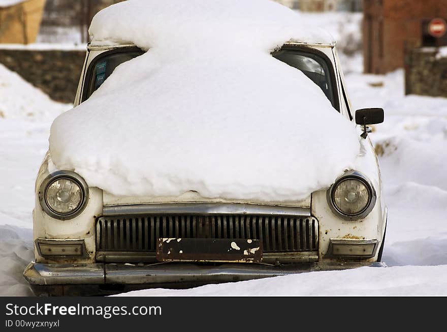 The old, Soviet, thrown car. It is removed on one of streets of the Russian city. Mark of the car Volga. The old, Soviet, thrown car. It is removed on one of streets of the Russian city. Mark of the car Volga.