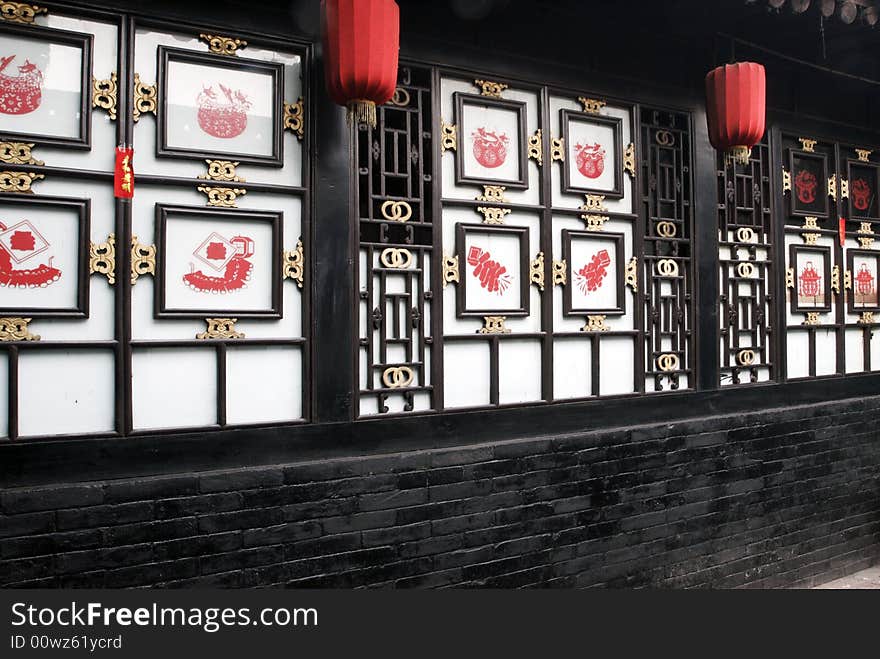 Ancient window of the old courtyard.

Chinese characters on the paper-cut are spring, meant spring came.

Chinese on in window frame the happy in the Spring Festival..