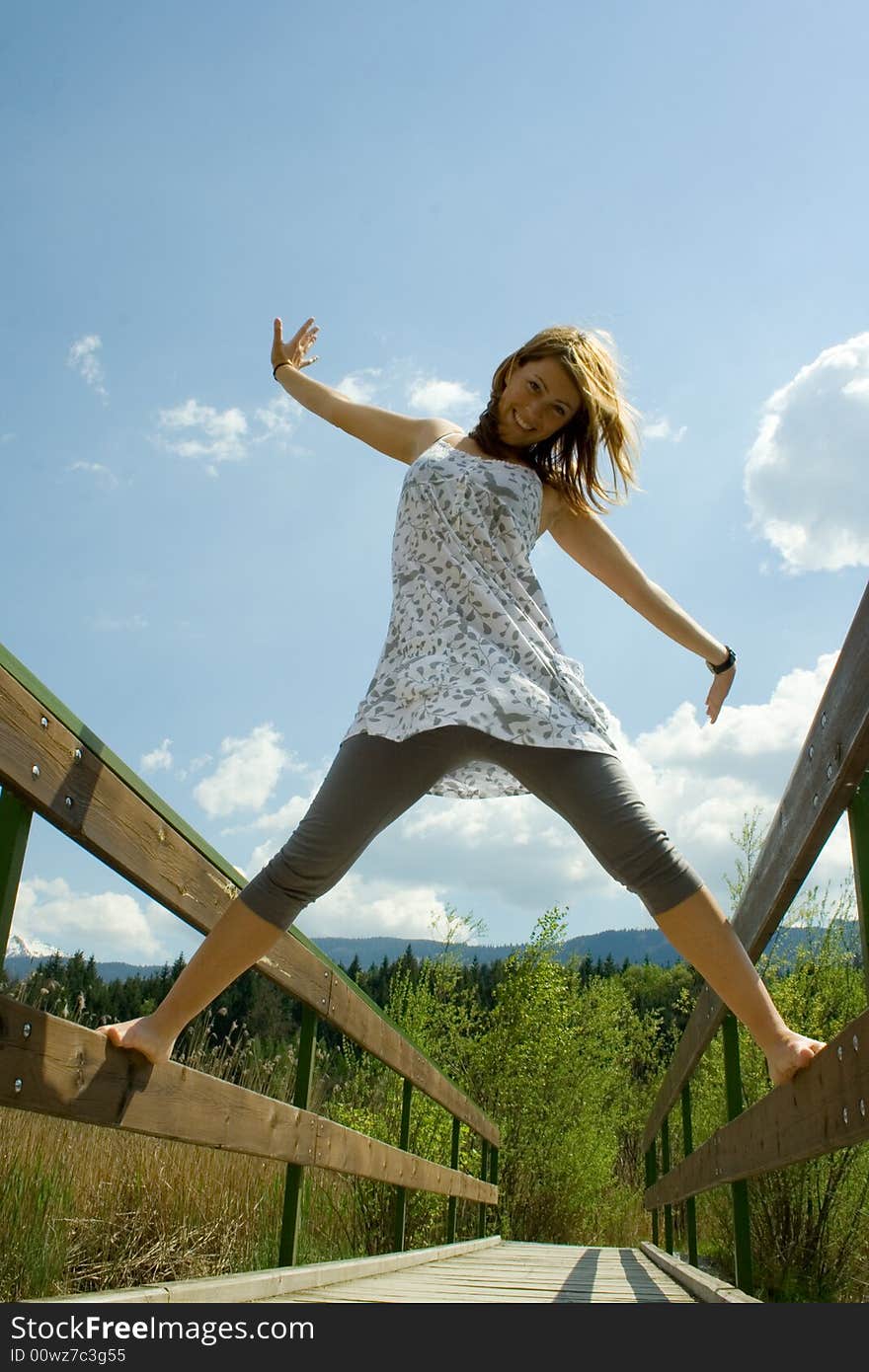 Beautiful girl on a bridge smiling