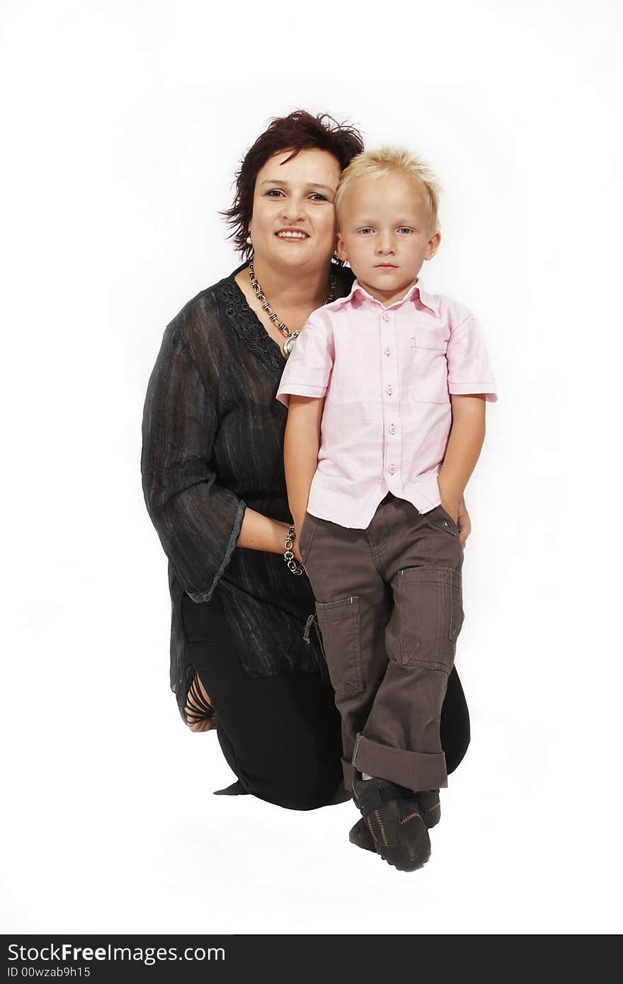 Woman kneeling behind boy in friendly condition while standing boy unfriendly. Woman kneeling behind boy in friendly condition while standing boy unfriendly